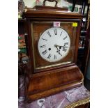 A 19th century Black Forest walnut mantel clock, 49cm high, with pendulum.