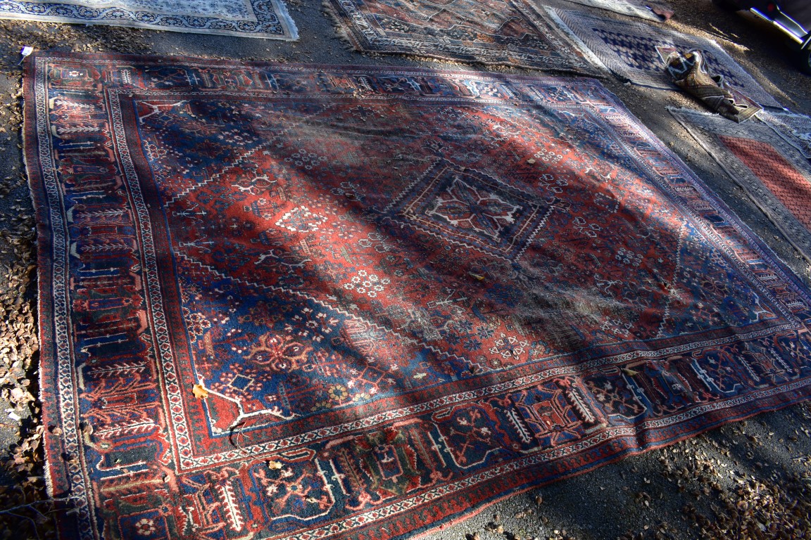 A large Persian rug, having central diamond medallion with allover floral central field, with - Image 2 of 5