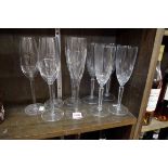 A collection of nine Waterford champagne flutes, comprising a set of four 'Marquis' pattern