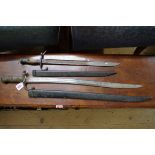 A French Model 1866 'Chassepot' yataghan sword bayonet and scabbard, dated 1870; and another bayonet
