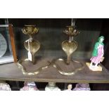 A pair of Eastern brass serpent candlesticks, 20cm high.