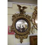 An antique gilt frame convex wall mirror, 90cm high.