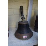 An old wall mounted bell, with clapper.