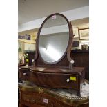 A George III mahogany toilet mirror.