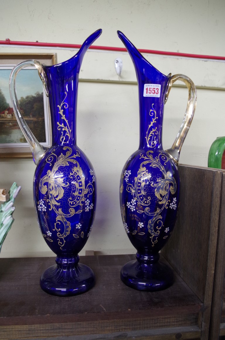 A pair of antique Continental blue glass ewers, 46.5cm high.