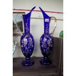 A pair of antique Continental blue glass ewers, 46.5cm high.