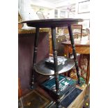 A late 19th century ebonized oval occasional table, the top inset with a painted pottery plaque,