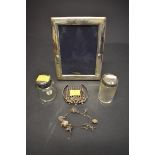 A small quantity of modern silver items, to include; a silver photograph frame; a silver charm