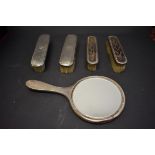 Three silver and tortoiseshell dressing table items; together with two silver backed brushes, (5).