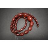 A string of graduated cherry amber style beads, 82cm, 42.5g.