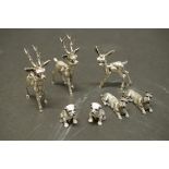 A collection of small silver animals, comprising three reindeer and four dogs, 194g.