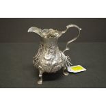 An ornate silver baluster cream jug, indistinct marks, 12cm, 149.5g.