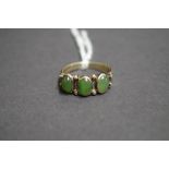 A jade three stone gold ring.