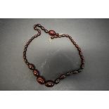 A string of graduated cherry amber style beads, 57cm, 35.5g