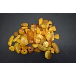 A quantity of butterscoth amber style loose random cut beads, 89.5g.