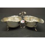 A silver sauce boat, Birmingham 1910, 8cm; together with a similar example, Birmingham 1916, 8.