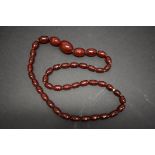 A string of graduated cherry amber style beads, 62cm, 36.3g