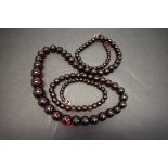 A string of graduated cherry amber style beads, 90cm, 48g