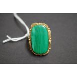 A yellow metal ring set large rectangular malachite.