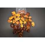 A string of graduated toffee amber style beads, 48cm, 16.5g; together with a chunky freeform