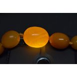 A string of graduated butterscotch amber style beads, 42.5cm, 37.6g