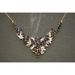An 18ct gold sapphire and diamond encrusted necklace.