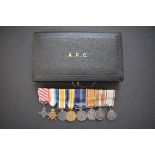 Medals: an Air Force Cross, boxed; together with a miniature group of eight to Group Capt. E.R.