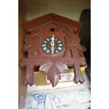 An old eight day cuckoo clock, with pine cone weights.