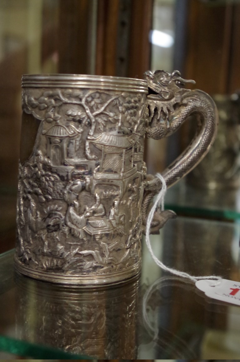 A Chinese silver tankard, with dragon handle and relief decoration, 167g, 9.5cm.