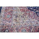 A fine and large Persian rug, having allover floral design on blue and salmon field, 406 x 297cm.