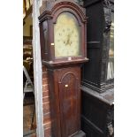 An early 19th century oak eight day longcase clock, the painted arched dial inscribed 'Jas