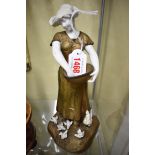 A bronze and parian figure of a farm girl, signed Mednat, 25.5cm high.