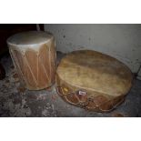 Two hide drums, largest 45.5cm wide.