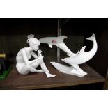 A Kaiser porcelain figure group of two dolphins, 18.5cm high; together with another Kaiser figure,