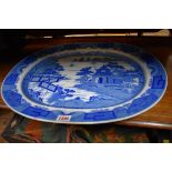 A 19th century English pottery blue and white meat plate, 52.5cm wide.