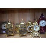 Seven various timepieces, to include three lantern style examples, largest 24cm high.