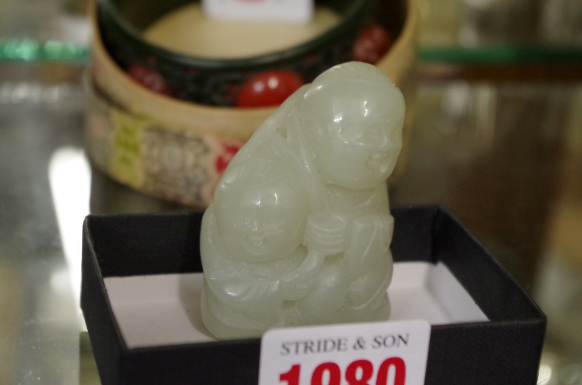 A Chinese carved celadon jade figure group, 5.8cm, high.