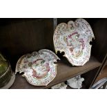 A pair of Continental pottery painted armorial dishes, of shaped outline, 23cm wide.