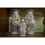 A pair of Chinese famille rose twin handled vases, 19th century, 23.5cm high; together with