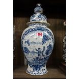 A 19th century Dutch Delft blue and white vase and cover, 36.5cm high, (damage and repair to cover).