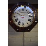 A Black Forest 30 hour wall clock, 32cm wide, with weights and pendulum.