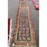 An Afghan runner, having repeated medallions to central field on a blue ground, with geometric