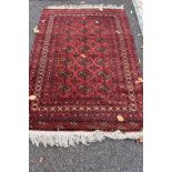A Bokhara rug,  having repeated medallions to central field with geometric border, 190 x 122cm.