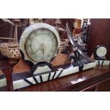 An Art Deco marble and onyx clock garniture, the clock 60cm wide.