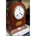 A mahogany and inlaid dome top mantel clock, 33cm high; together with a pair of coastal paintings by