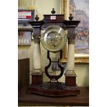 An Austrian Empire style stained wood and alabaster mantel clock, with silk suspension and repeater,