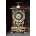 A reproduction French Empire style mahogany and brass mantel clock, 31cm high.