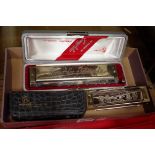 A Hohner 'Larry Adler professional 16' harmonica, boxed; together with another Hohner '