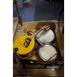 An eight string banjo; together with a mandolin; and other musical instruments.