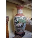 A Chinese famille rose vase, painted with pea fowl, 35cm high, on wood stand.